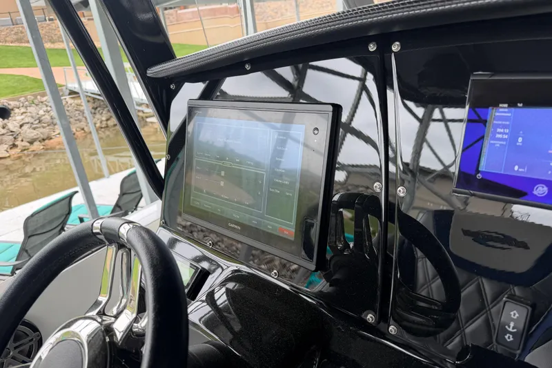 Slide: The Image of 2018 Sunsation 32 CCX boat dashboard with Garmin navigation display and steering wheel. - 21