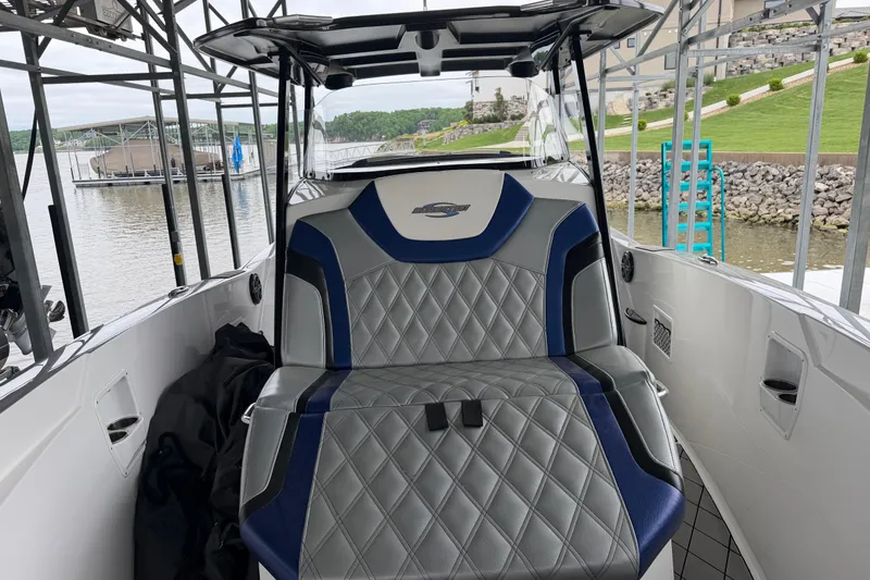 Slide: The Image of 2018 Sunsation 32 CCX boat interior with stylish seating at a marina. - 23