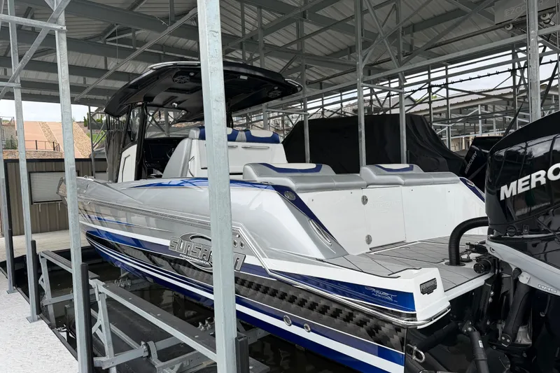 Slide: The Image of 2018 Sunsation 32 CCX boat in storage, featuring sleek design and powerful Mercury engines. - 3