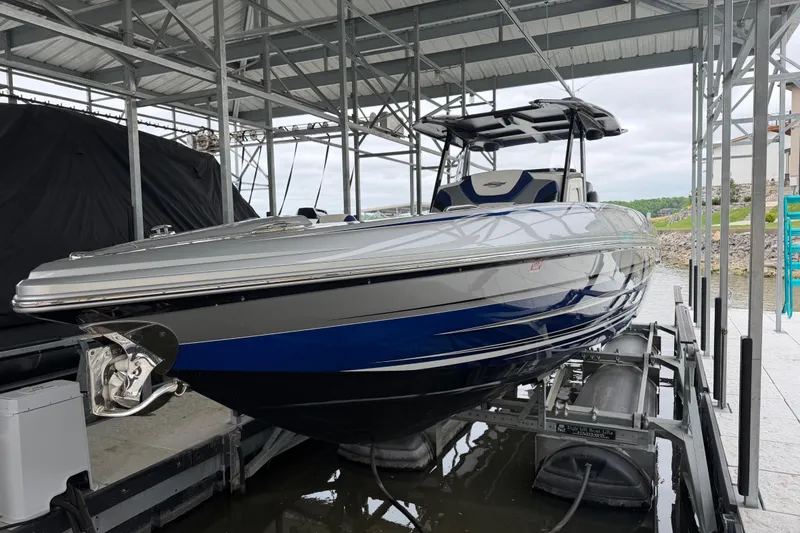 Slide: The Image of 2018 Sunsation 32 CCX boat in dock, featuring sleek blue and silver design. - 5