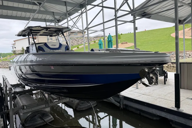 Slide: The Image of 2018 Sunsation 32 CCX boat docked under a covered marina. - 6