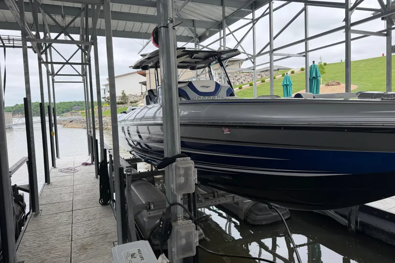 Slide: The Image of 2018 Sunsation 32 CCX boat docked under a covered marina. - 7