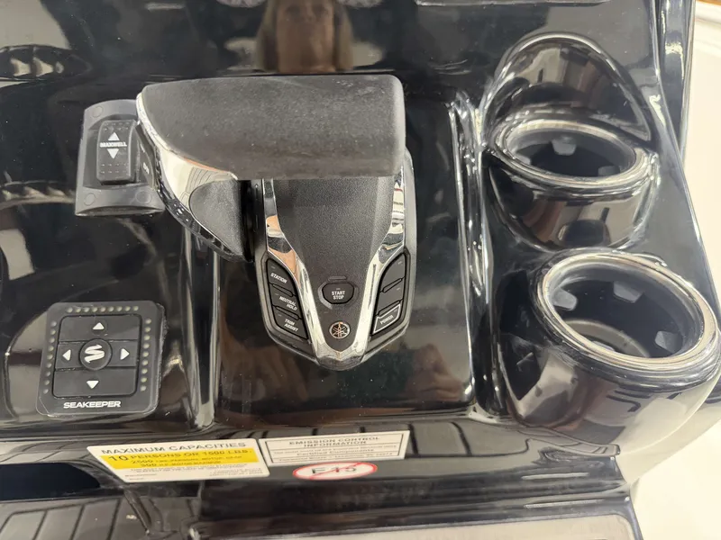 Slide: The Image of Tidewater 232 CC Adventure 2026 helm with controls and cup holders. - 24