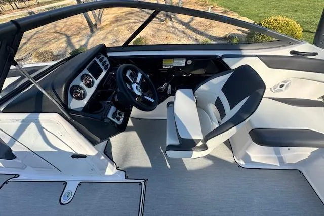 Slide: The Image of 2021 Yamaha AR 210 boat interior with steering wheel and seating. - 14