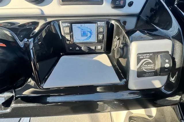 Slide: The Image of Dashboard of a 2021 Yamaha AR 210 boat with navigation controls. - 18