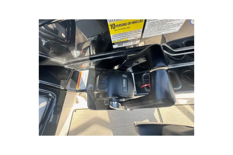 Slide: The Image of 2021 Yamaha AR 210 boat throttle control and capacity label, accommodating up to 10 persons. - 22