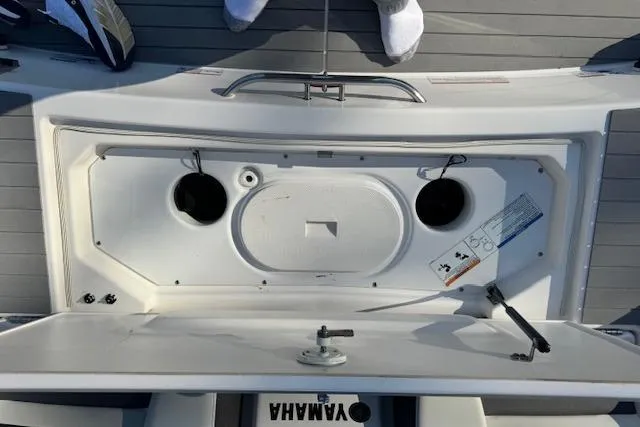 Slide: The Image of 2021 Yamaha AR 210 boat deck with storage compartment and visible fittings. - 23