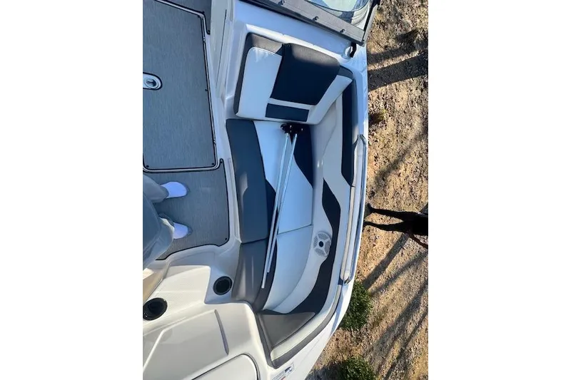 Slide: The Image of 2021 Yamaha AR 210 boat interior with gray and white seating. - 24