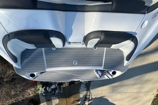 Slide: The Image of 2021 Yamaha AR 210 boat deck with seating and storage compartments. - 31