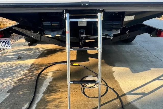 Slide: The Image of Rear view of a 2021 Yamaha AR 210 boat with a metal ladder. - 34