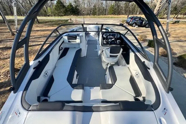 Slide: The Image of 2021 Yamaha AR 210 boat interior with sleek seating and modern dashboard design. - 9