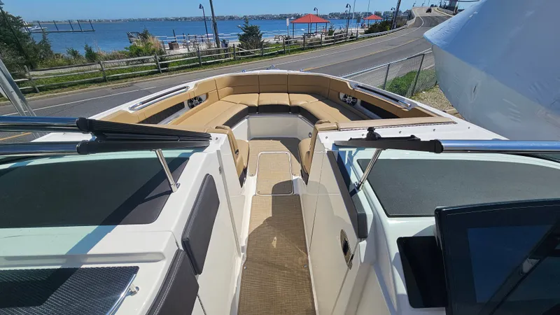 Slide: The Image of 2023 Sea Ray SLX 310 Outboard with spacious deck and waterfront view. - 34