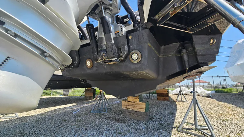 Slide: The Image of Underside of a 2023 Sea Ray SLX 310 Outboard on stands. - 9