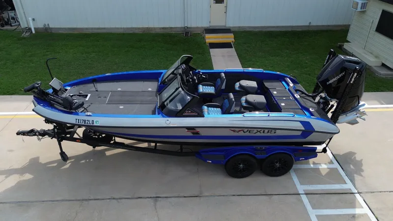 Slide: The Image of 2025 Vexus DVX22S boat on trailer, blue and black. - 12