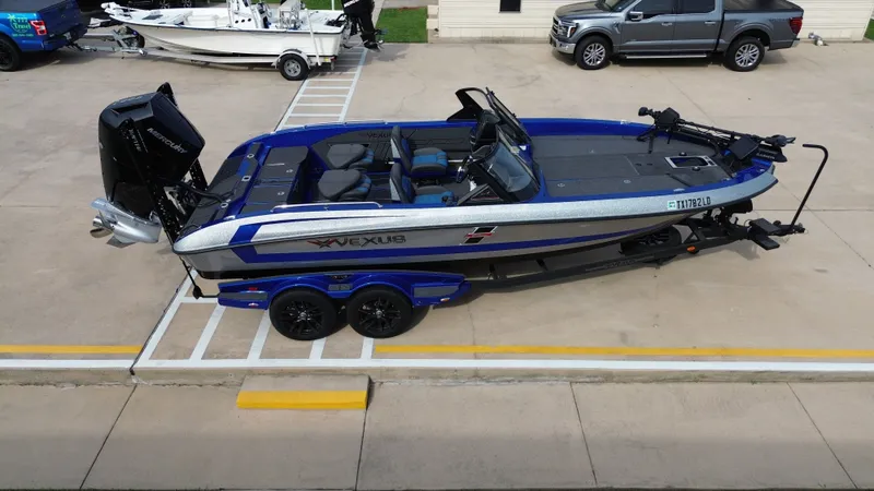 Slide: The Image of 2025 Vexus DVX22S boat on trailer, blue and silver, side view. - 16