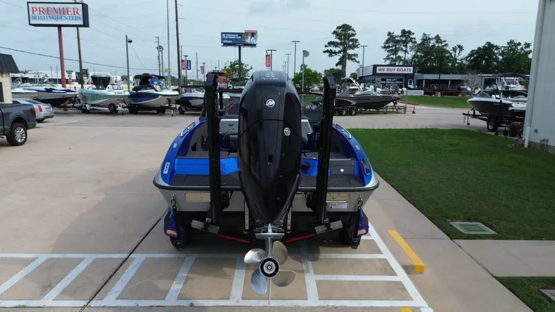 Slide: The Image of Rear view of a blue 2025 Vexus DVX22S boat in a parking lot. - 5