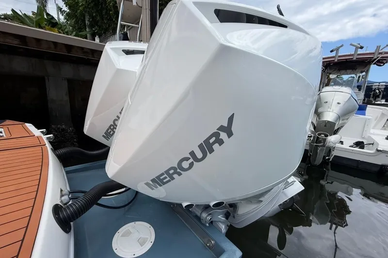 Slide: The Image of 2025 NX Boats 340 Sport Coupe with Mercury outboard engines docked. - 18