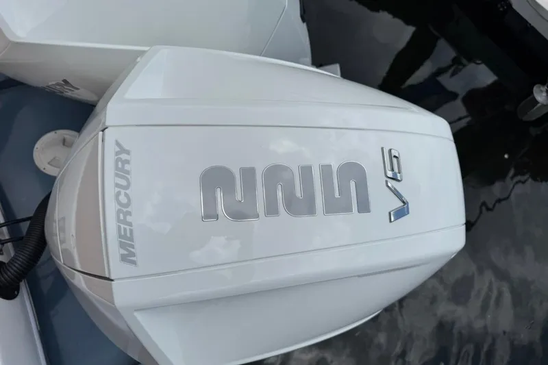 Slide: The Image of Mercury V6 engine on 2025 NX Boats 340 Sport Coupe, docked on water. - 19
