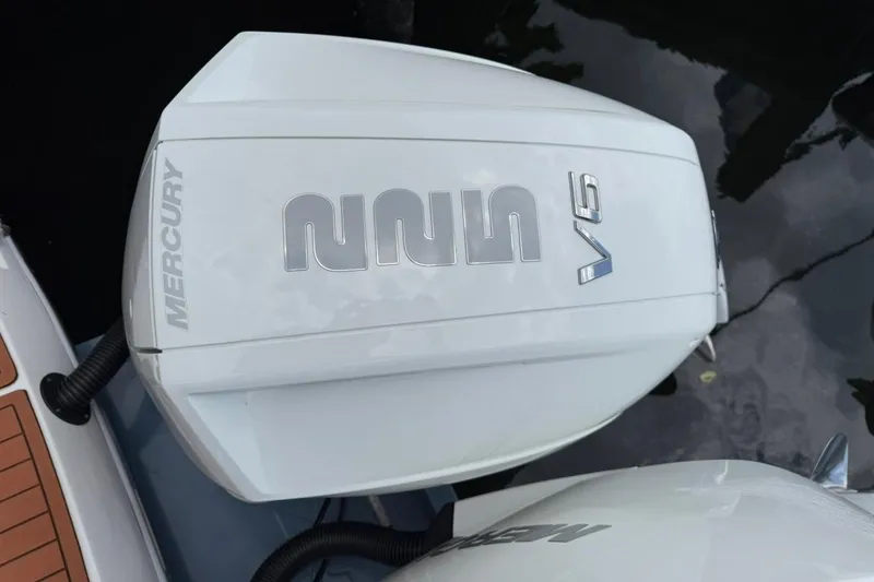 Slide: The Image of Mercury V6 engine on NX Boats 340 Sport Coupe, 2025 model, docked on water. - 20