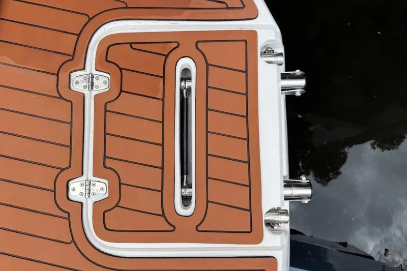 Slide: The Image of 2025 NX Boats 340 Sport Coupe swim platform with teak-style decking and stainless steel fittings. - 21