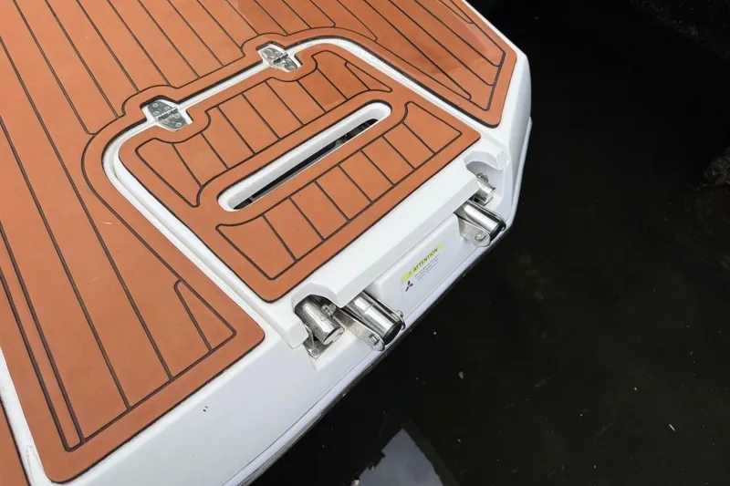 Slide: The Image of 2025 NX Boats 340 Sport Coupe swim platform with teak-style decking. - 22
