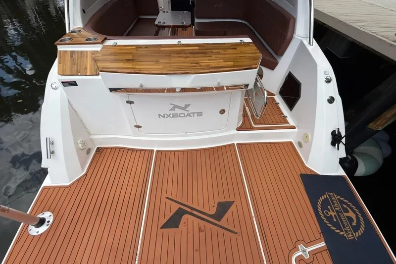 Slide: The Image of 2025 NX Boats 340 Sport Coupe with teak deck and stylish interior. - 23