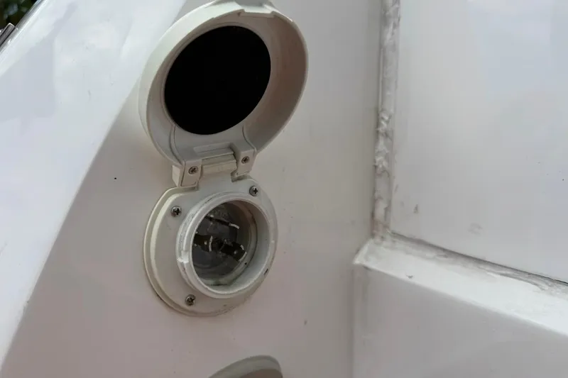 Slide: The Image of Power socket on 2025 NX Boats 340 Sport Coupe, white exterior detail. - 28