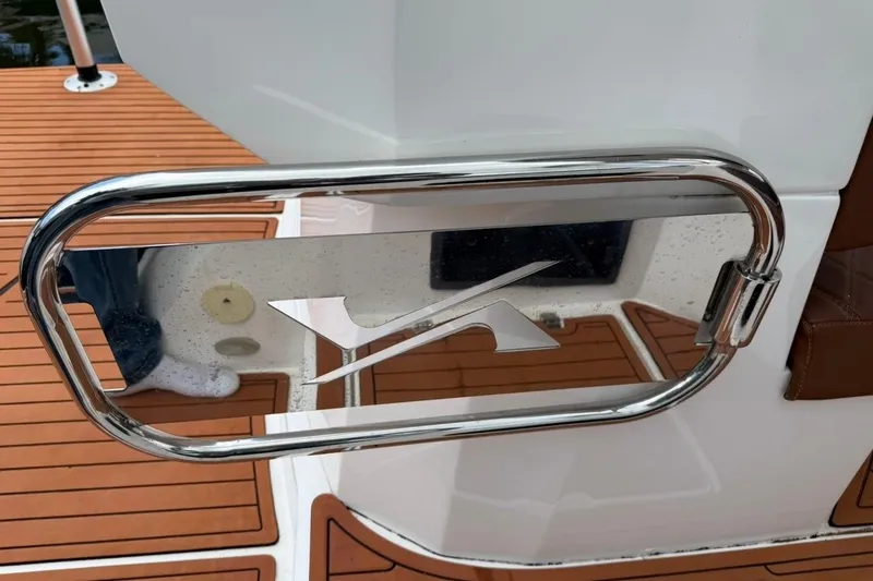 Slide: The Image of 2025 NX Boats 340 Sport Coupe, chrome detail on teak deck. - 32