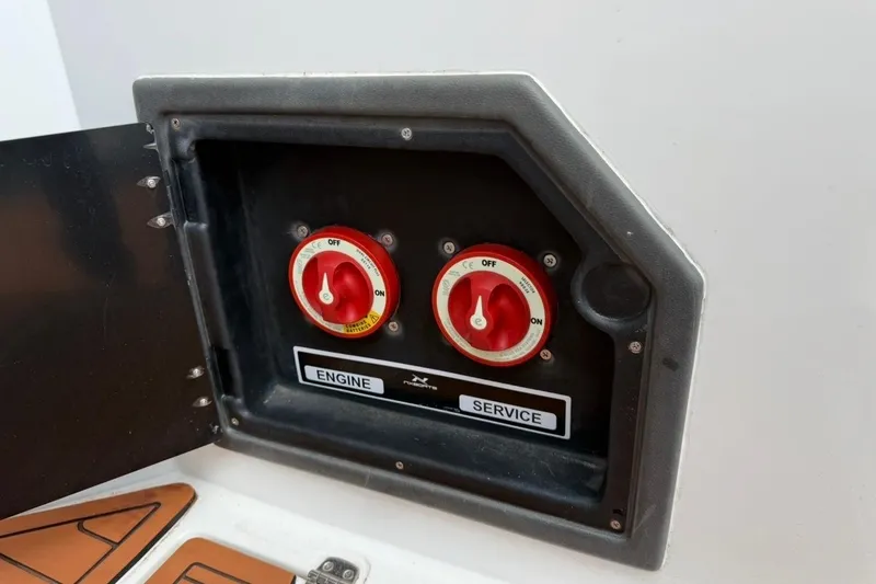 Slide: The Image of Control panel of 2025 NX Boats 340 Sport Coupe with engine and service switches. - 33