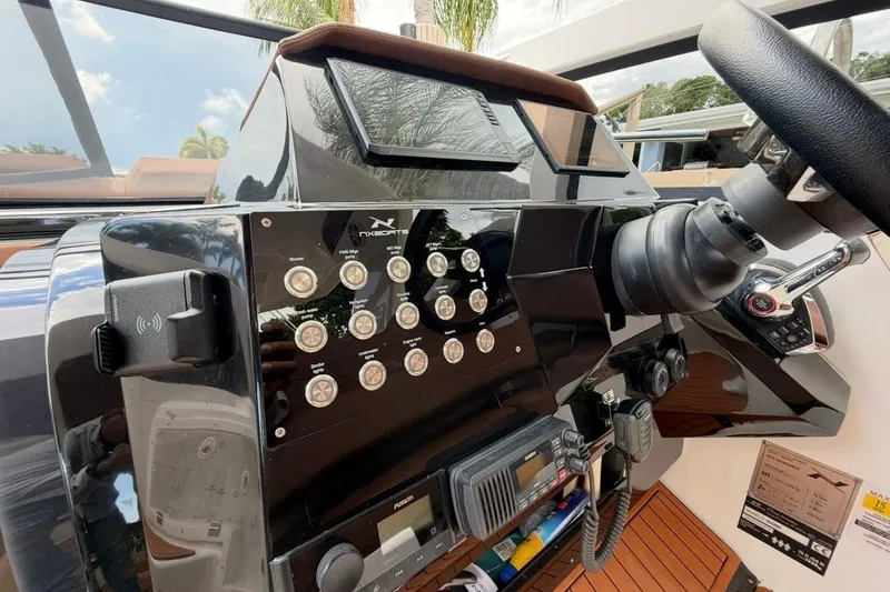 Slide: The Image of Control panel of 2025 NX Boats 340 Sport Coupe, featuring modern navigation and communication equipment. - 43