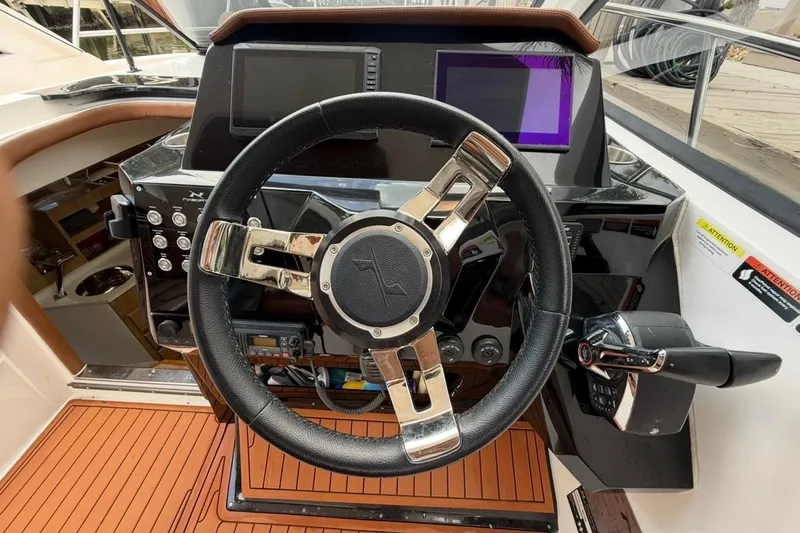 Slide: The Image of Steering wheel and dashboard of 2025 NX Boats 340 Sport Coupe. - 45