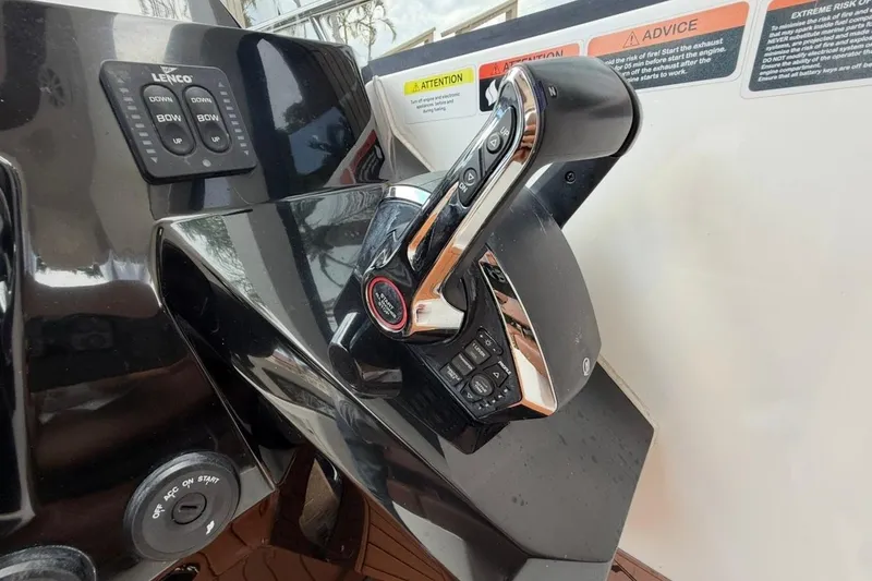 Slide: The Image of Control panel of 2025 NX Boats 340 Sport Coupe with throttle and bow controls. - 46