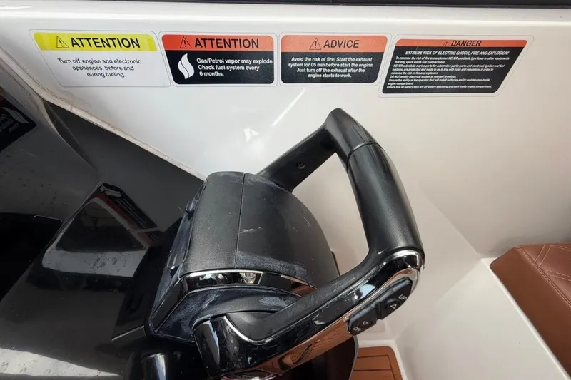 Slide: The Image of Throttle control and safety warnings on 2025 NX Boats 340 Sport Coupe dashboard. - 47