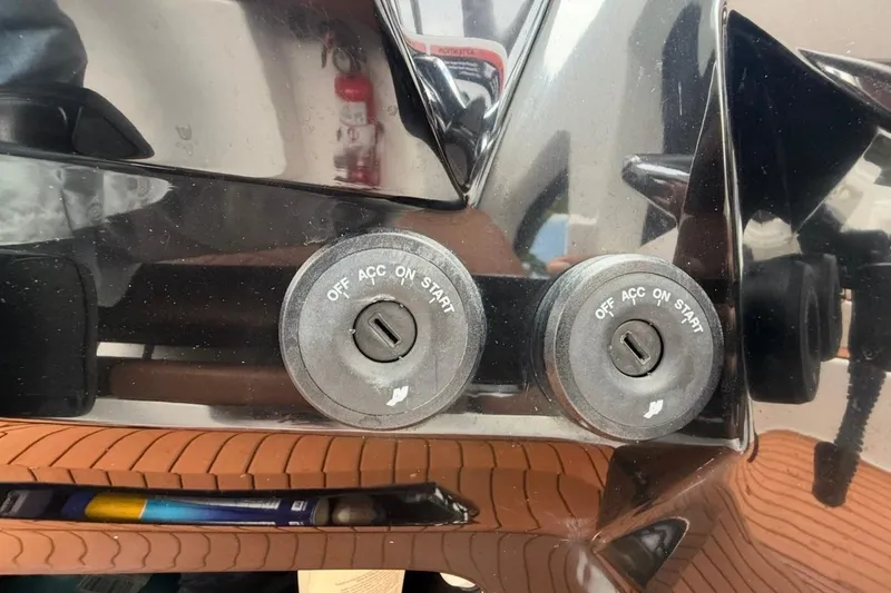 Slide: The Image of Dual ignition switches on a 2025 NX Boats 340 Sport Coupe dashboard. - 49