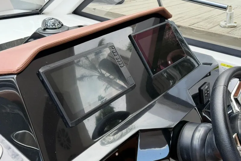 Slide: The Image of Dashboard of 2025 NX Boats 340 Sport Coupe with modern navigation screens. - 50