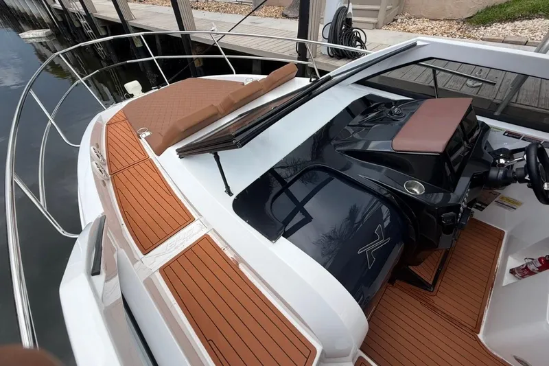 Slide: The Image of 2025 NX Boats 340 Sport Coupe with sleek design and luxurious deck features. - 55