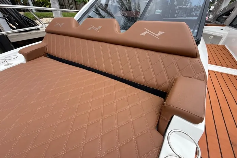 Slide: The Image of Luxurious brown leather seating on 2025 NX Boats 340 Sport Coupe, featuring diamond stitching. - 59