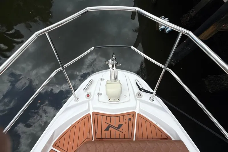 Slide: The Image of Bow view of 2025 NX Boats 340 Sport Coupe with sleek railings and deck design. - 61