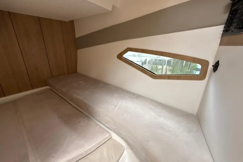 Slide: The Image of Interior cabin of 2025 NX Boats 340 Sport Coupe with modern design and window view. - 75