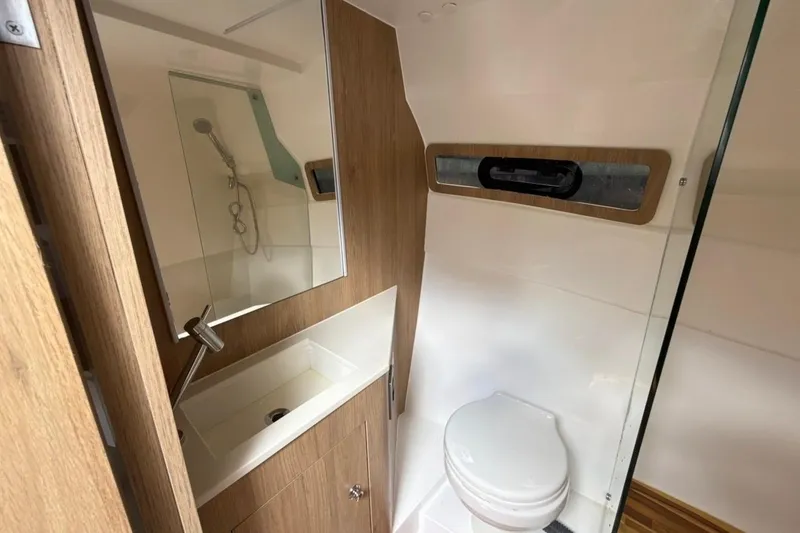 Slide: The Image of Modern bathroom in 2025 NX Boats 340 Sport Coupe with wood accents and compact design. - 77