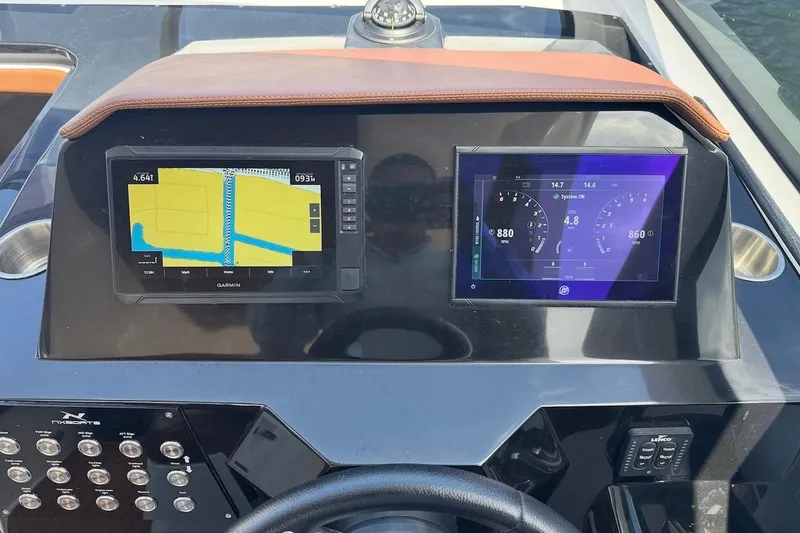 Slide: The Image of Dashboard of 2025 NX Boats 340 Sport Coupe with navigation and control screens. - 78