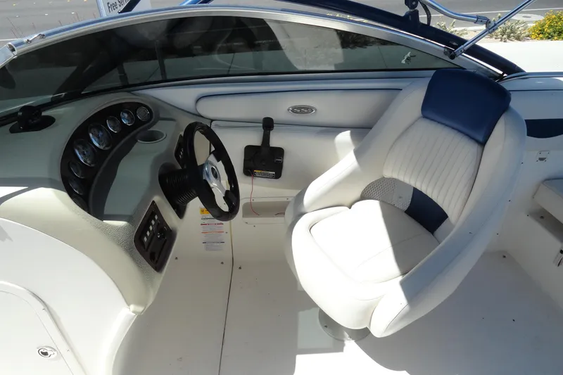 Slide: The Image of Interior of a 2003 Chaparral 220 SSi boat featuring steering wheel and captain's seat. - 10