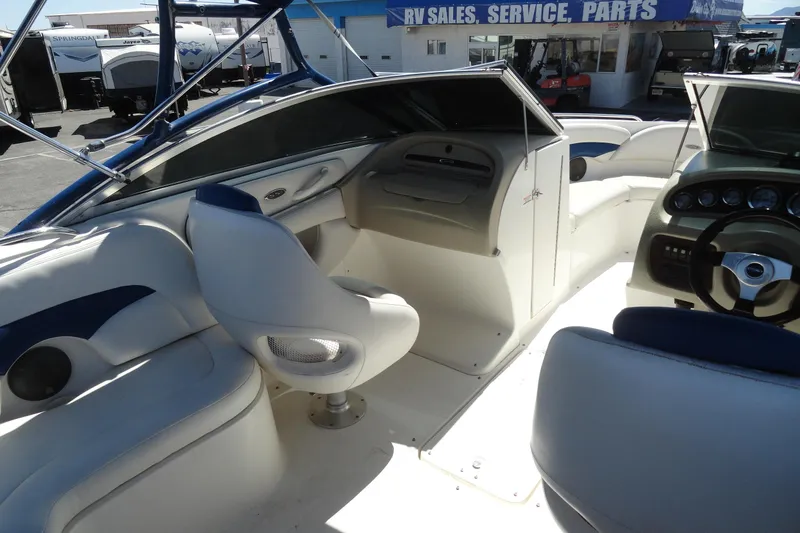 Slide: The Image of Interior of a 2003 Chaparral 220 SSi boat, featuring seating and dashboard controls. - 13