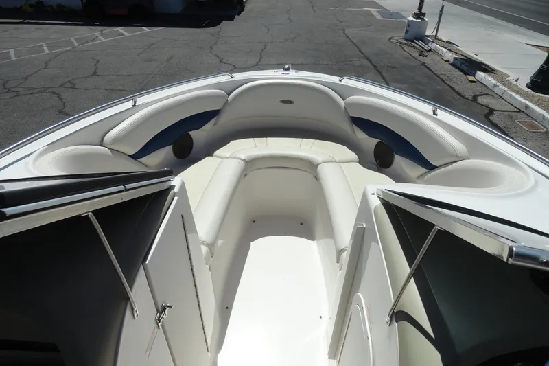 Slide: The Image of 2003 Chaparral 220 SSi boat interior with white seating and open storage compartments. - 14
