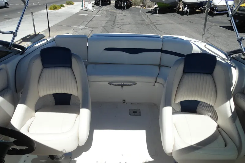 Slide: The Image of Interior of a 2003 Chaparral 220 SSi boat with white and blue seating. - 15