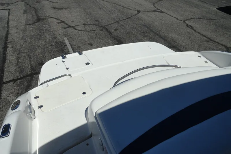 Slide: The Image of 2003 Chaparral 220 SSi boat deck, white surface with storage compartments. - 17