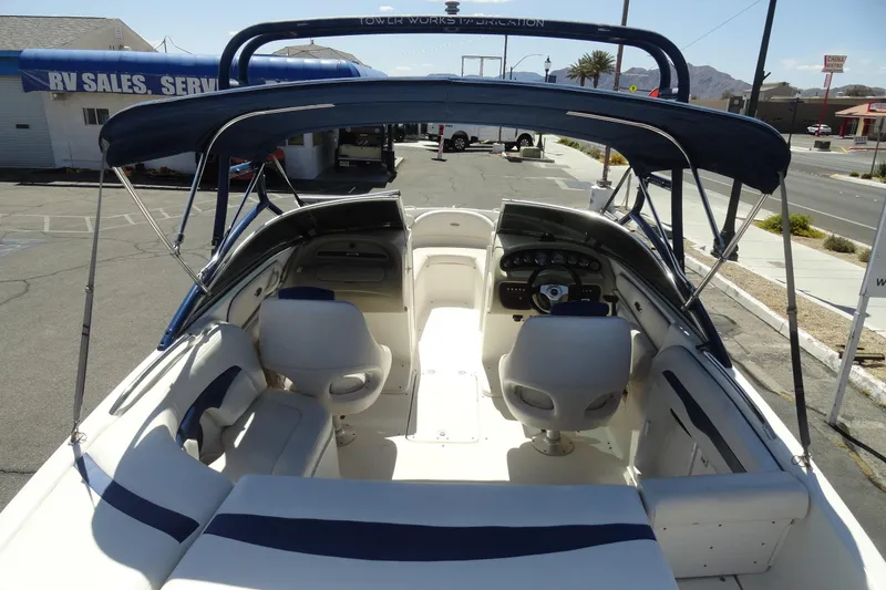 Slide: The Image of 2003 Chaparral 220 SSi boat interior with seating and dashboard, parked near RV sales. - 6