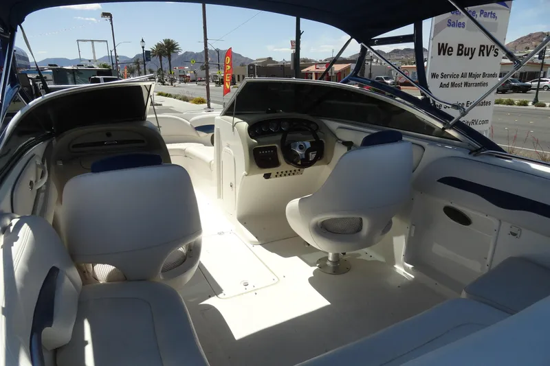 Slide: The Image of Interior view of a 2003 Chaparral 220 SSi boat with seating and steering wheel. - 7