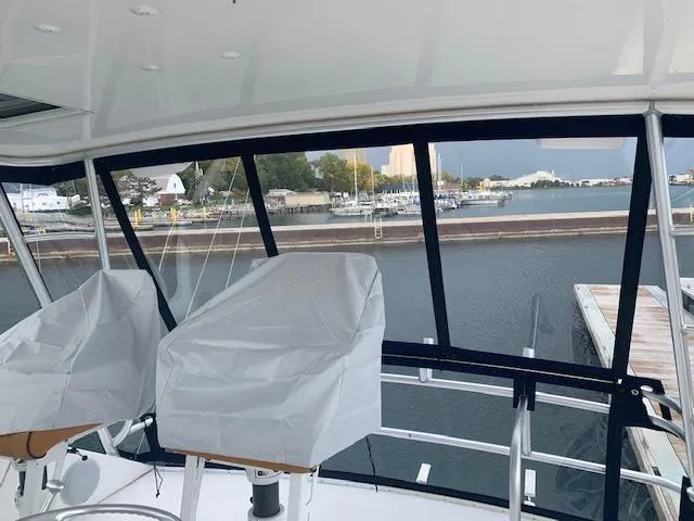 Slide: The Image of 2002 Viking 55 Convertible yacht interior with marina view through large windows. - 16