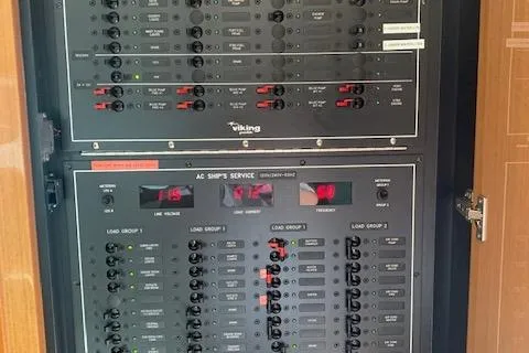 Slide: The Image of Electrical panel of a 2002 Viking 55 Convertible yacht, featuring various switches and controls. - 25